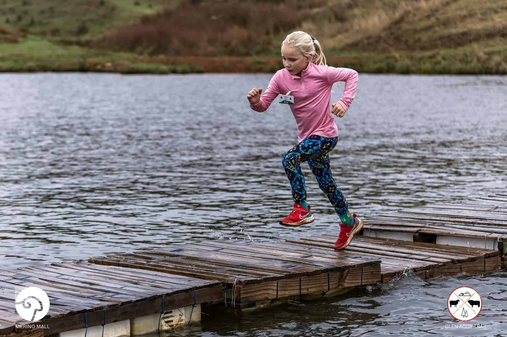 Carolien Grobbelaar crossing the water bridge during the Glen Aggy Trail Run in Amsterdam.