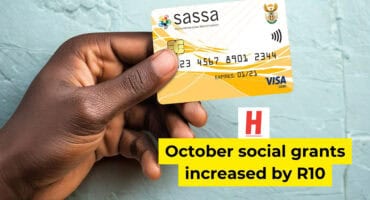 Person holding a yellow SASSA social grant payment card in South Africa.