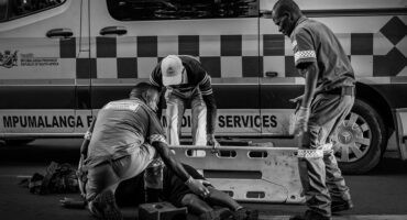 Alt text: Paramedics assist a woman injured after being struck by a taxi near the Pick n Pay robot in Ermelo.