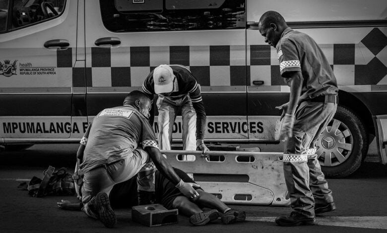 Alt text: Paramedics assist a woman injured after being struck by a taxi near the Pick n Pay robot in Ermelo.