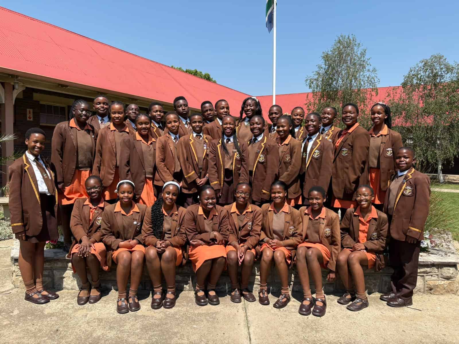 Grade 7 learners from Ermelo English Primary School proudly display their Term 3 achievement certificates.
