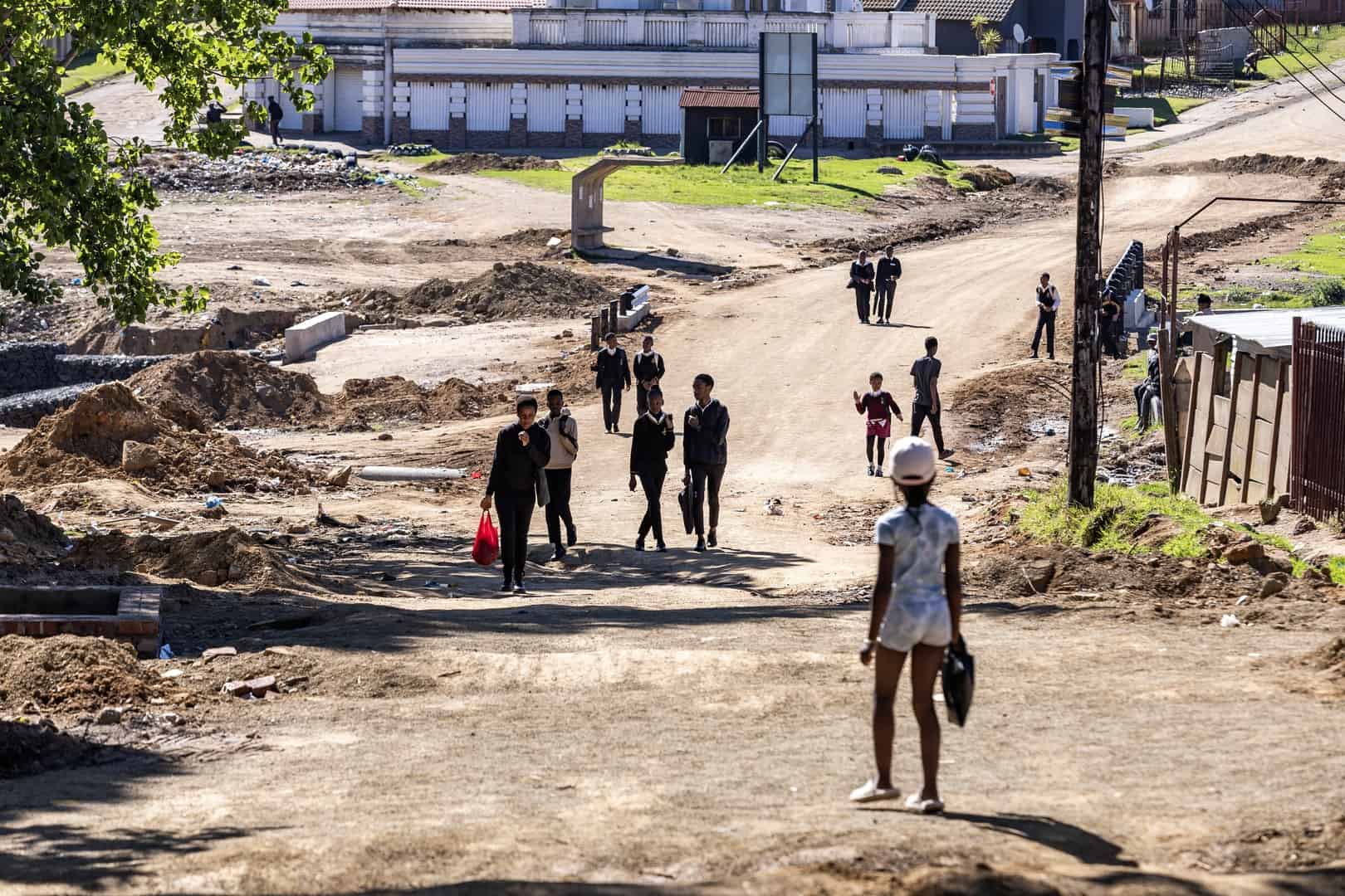 School children and pedestrians walking along Magwaza Street in Wesselton, which remains closed to traffic and requires a detour.
