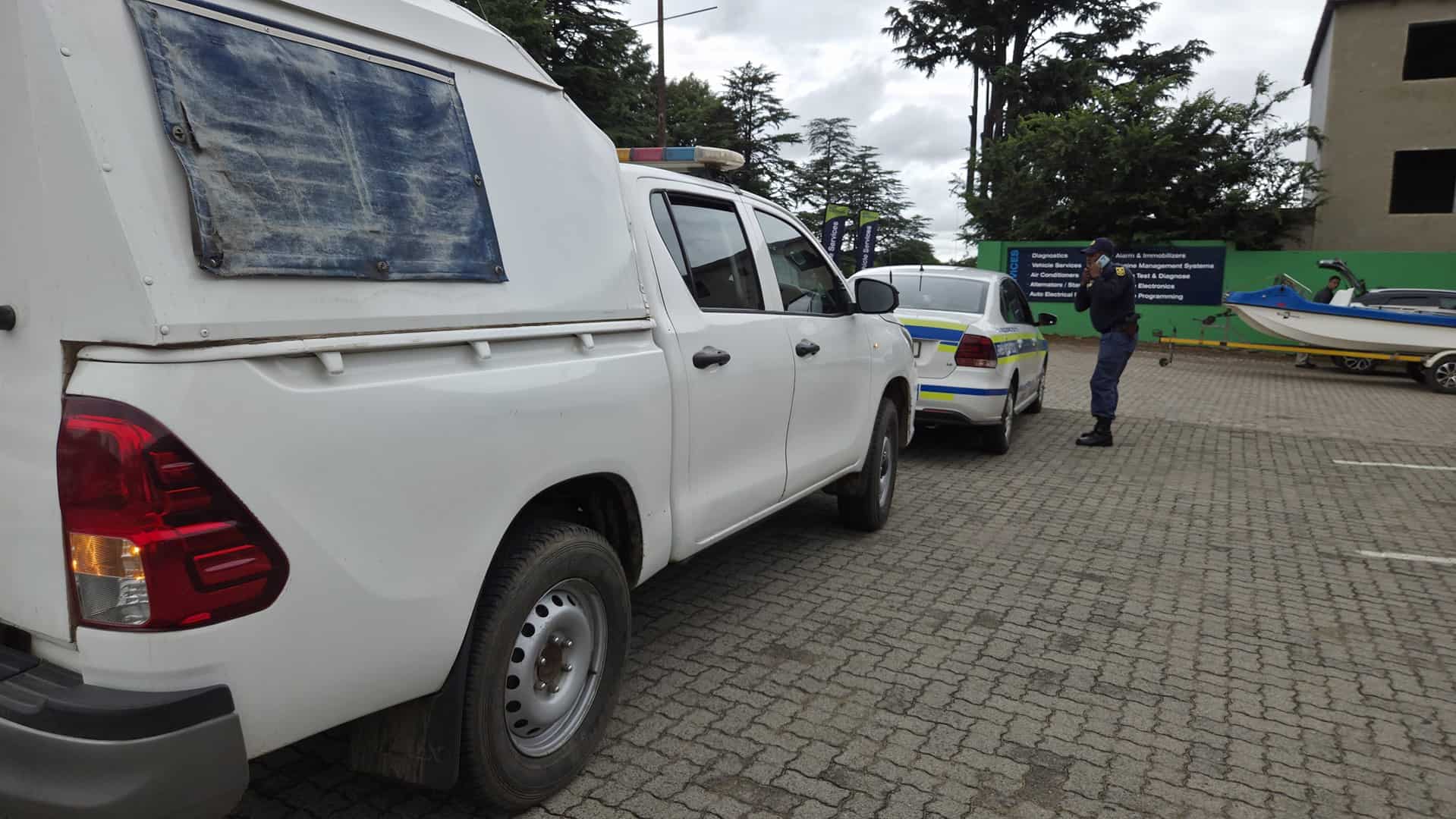 Police vehicles parked at Merino Mall, blocking off the SANBS Jail & Bail scene.