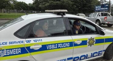 René Joubert seated in the back of a police vehicle during the SANBS Jail & Bail fundraiser at Merino Mall.