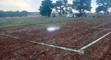 Police cordon off the body of a woman who died in a farm accident near Breyten