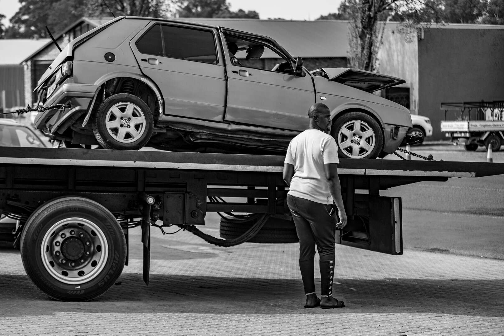 Norman Booi loading a damaged vehicle onto his tow truck during a recovery.