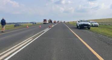 Distant view of a head-on collision on the N11 near Ermelo, showing wrecked vehicles and the roadway.