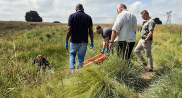 Alwyn van der Linde descends an embankment to recover a body from the Ermelo quarry