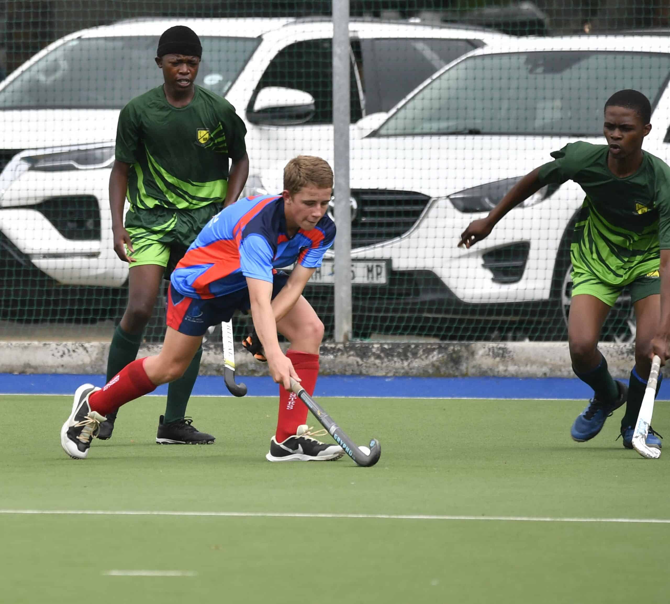 Regardt Schoonraad met balbesit tydens seunshokkie wedstryd.