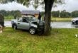 Damaged Nissan bakkie resting against a tree after Ermelo intersection accident.
