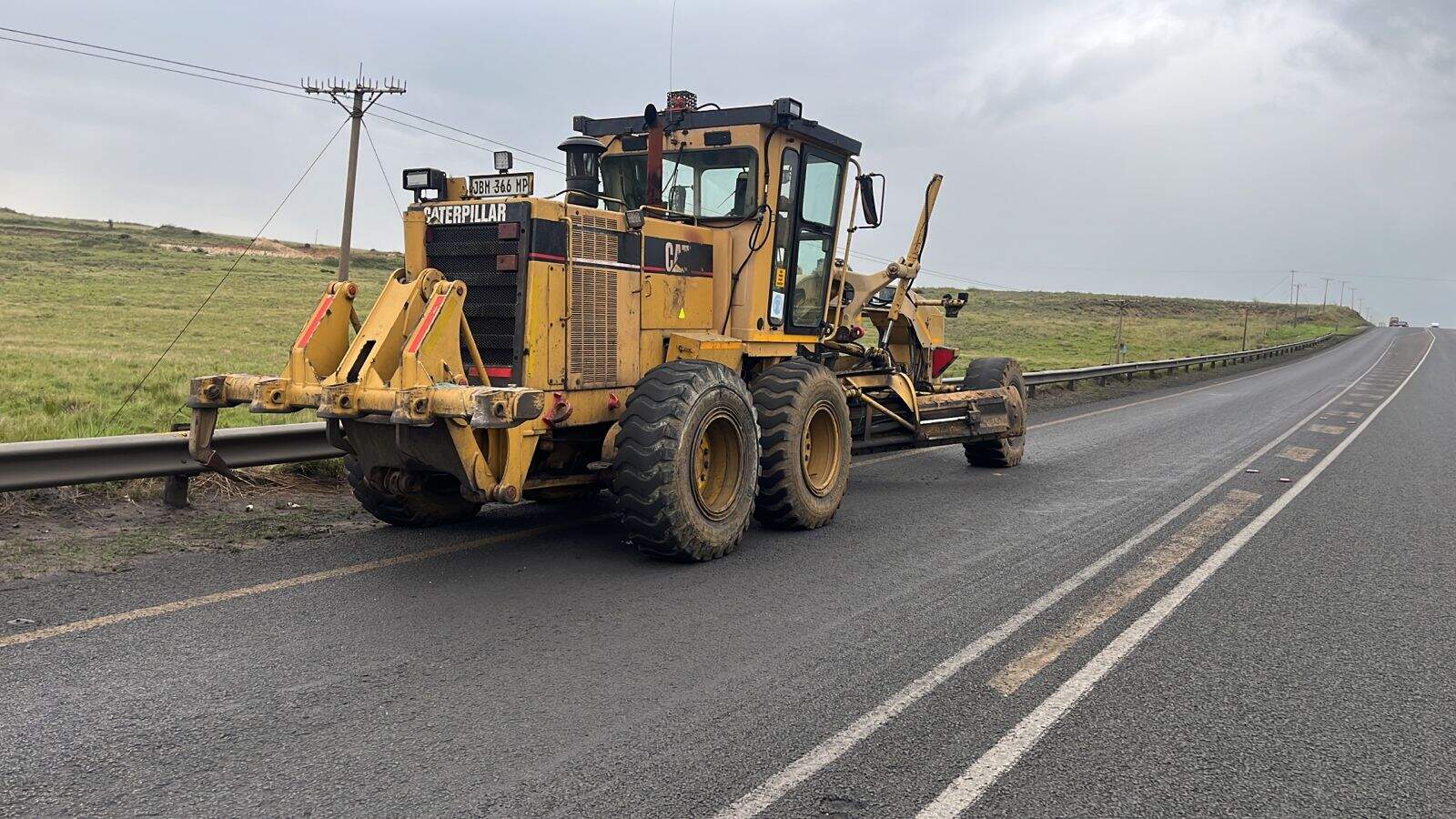 Grader parked on the side of Piet Retief Road after accident with bakkie