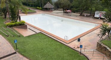 Empty resort pool at Badplaas undergoing post-flood restoration