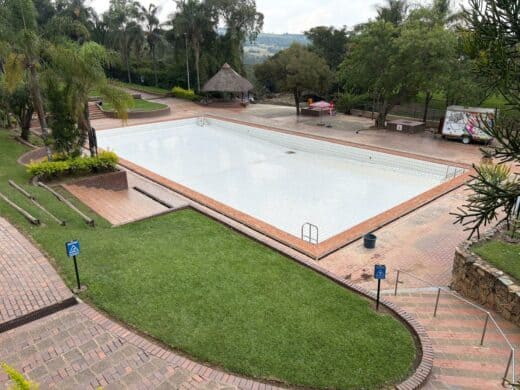 Empty resort pool at Badplaas undergoing post-flood restoration