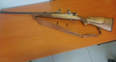 Musgrave self-loading rifle placed on a table as evidence