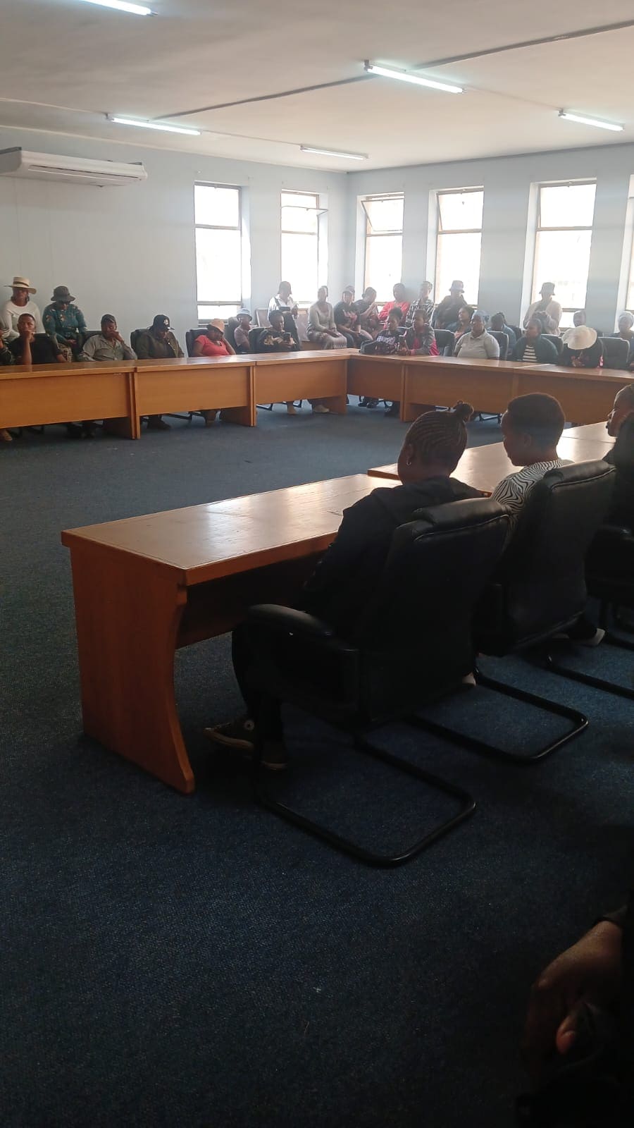 Parents seated in Department of Education boardroom in Ermelo