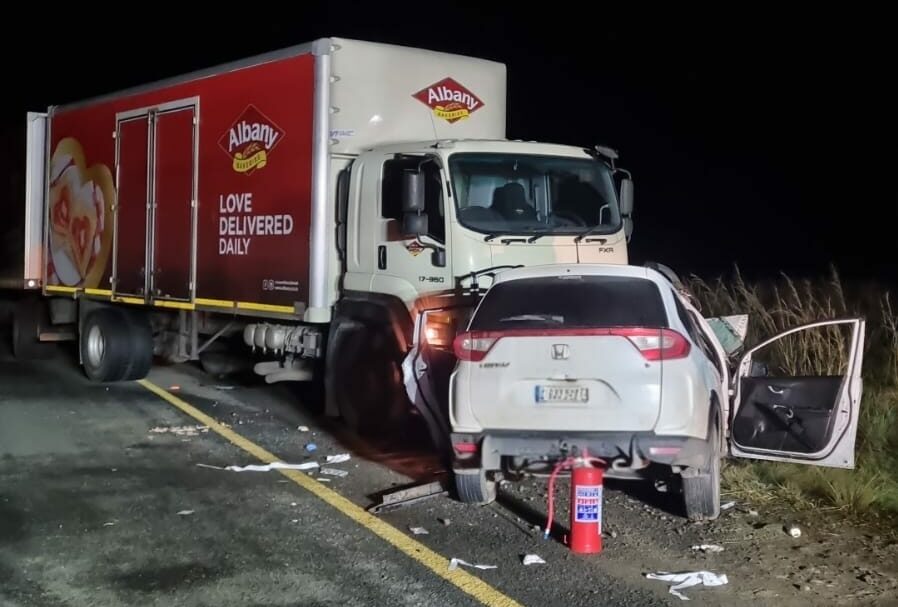 Damaged sedan and truck after head-on crash on the R23 between Volksrust and Perdekop