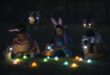 Children hunting glowing Easter eggs at night in Ermelo with flashlights