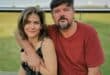 John Wickham posing with his wife Magda in a family photograph.