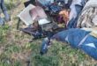 Burnt household items and damaged belongings are scattered outside a fire-damaged home after a destructive blaze.