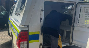 A woman suspected of a crime entering a SAPS police van after an arrest in Jansen Street.