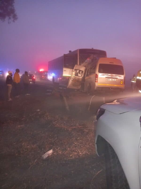 Wrecked taxi and bus on the R39 Road under misty weather conditions.