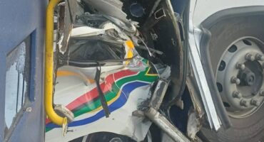 Severely damaged minibus taxi and bus after fatal R39 collision near Standerton.
