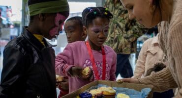 René Joubert handing out cupcakes to children at Ermelo Toyota Legend Fest