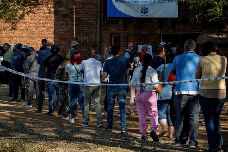 People waiting in line outside a polling station.