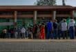 Residents queue at a voting station during an election.
