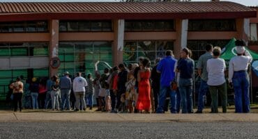 Residents queue at a voting station during an election.