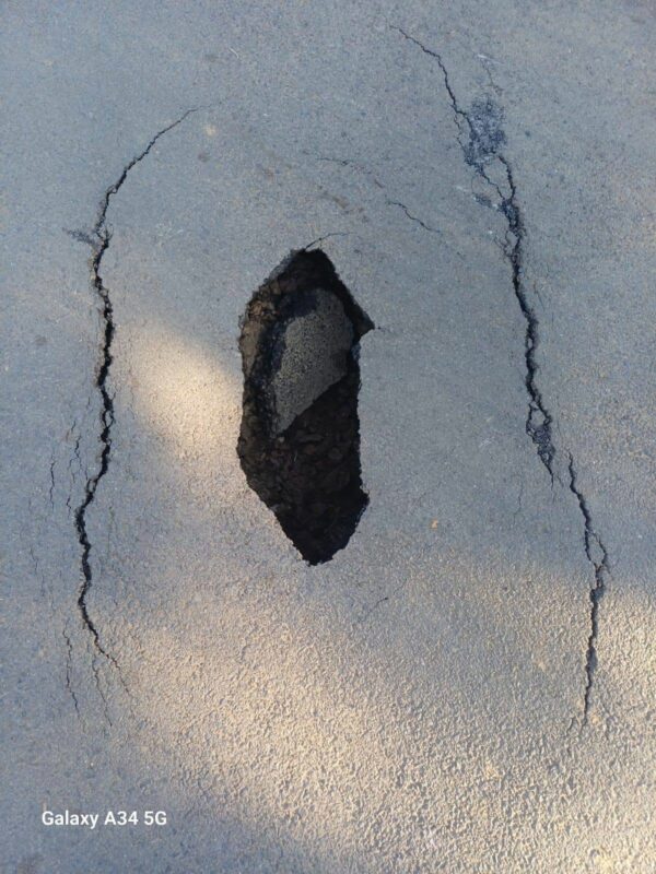 Deep pothole at the T-junction near Netherland Park Secondary School.