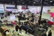 Visitors browse stalls and gather inside the Ermelo Toyota showroom during the Legend Fest despite cold winter weather.