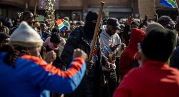 Large crowd of protesters gathered at a central intersection in Ermelo.