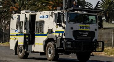 Armoured police vehicle moving through Ermelo CBD toward Msukaligwa Municipality