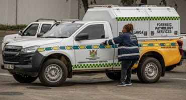 Forensic Pathology Services vehicles parked near the scene where an unidentified man was found in Ermelo.