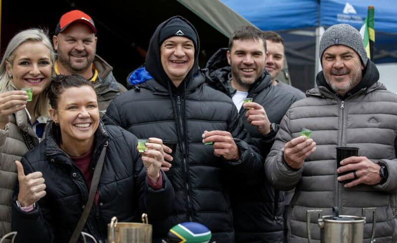 A group of friends pose for a photo while finding creative ways to keep the winter chill at bay during the Ermelo Toyota Legend Fest.