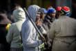 Masked protester holding a baton during a public gathering in Ermelo.