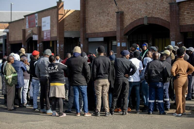 Small group of people gathered at the Ermelo traffic circle during a community meeting.
