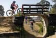 Young cyclists negotiate the bridge obstacle during the TWK XCO Mountain Biking event at Ligbron Akademie in Ermelo.