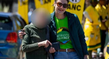 Patriotic Alliance MP Juliet Basson poses with a supporter during a party event.