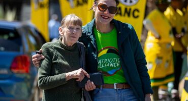 Patriotic Alliance MP Juliet Basson poses with a supporter during a party event.