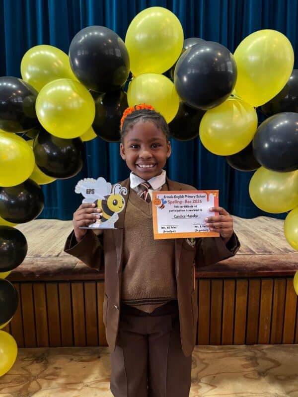 Grade 1 spelling bee champion Candice Maseko from Ermelo English Primary School holding her trophy and certificate.