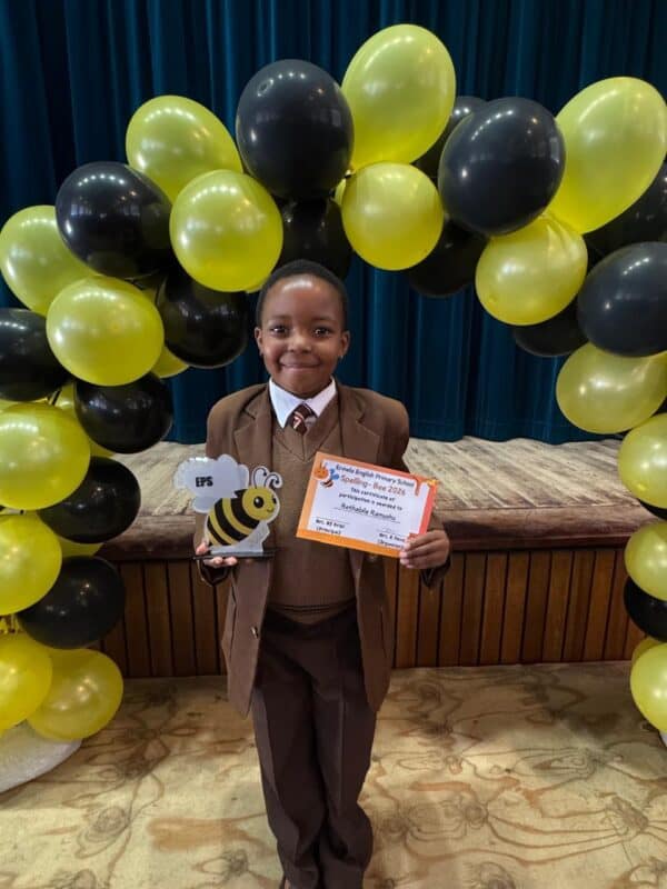 Grade 2 spelling bee champion Rethabile Ramushu from Ermelo English Primary School holding her trophy and certificate.