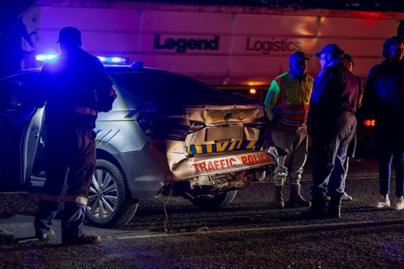 Emergency personnel inspect the rear of a damaged Msukaligwa Traffic Department vehicle after the collision.