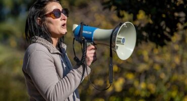 Archive photo of Juliet Basson speaking into a megaphone.