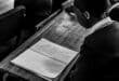 Learner rehearses a poem from an open book before reciting it to her peers during the BookHive programme.