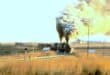Two Class 24 steam locomotives depart Breyten with the 06:00 freight service to Lothair on May 3, 1983.