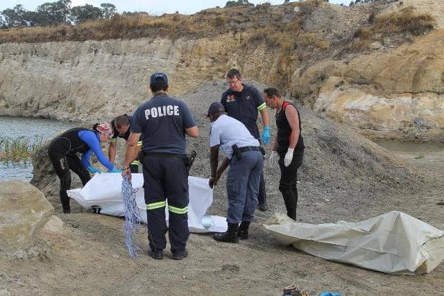 Police divers recover the bodies of two teenagers from an abandoned mining pit in 2016.