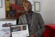Fanie Mphutha holding his third-place digital reporting award from the 2025 AVBOB FCJ Excellence Awards