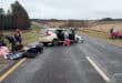 Two vehicles damaged in a serious collision on the R33 near Amsterdam, with several people visible at the roadside.